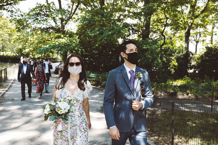 bride and groom with masks