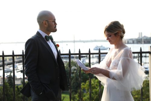 A couple reading vows during their Brooklyn Promenade wedding ceremony