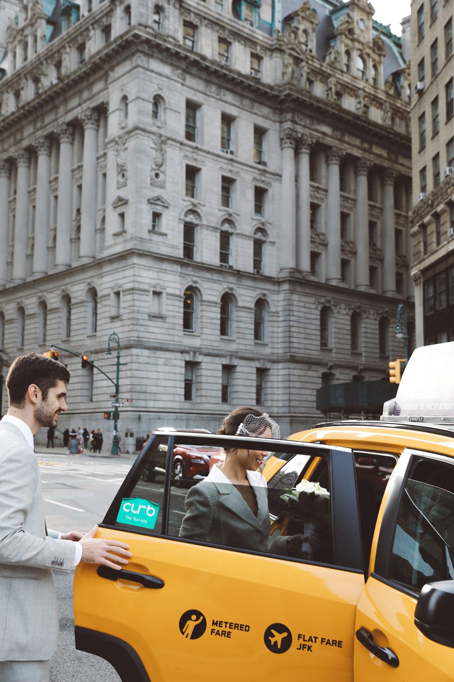 Couple taking a yellow cab for their NYC Elopement