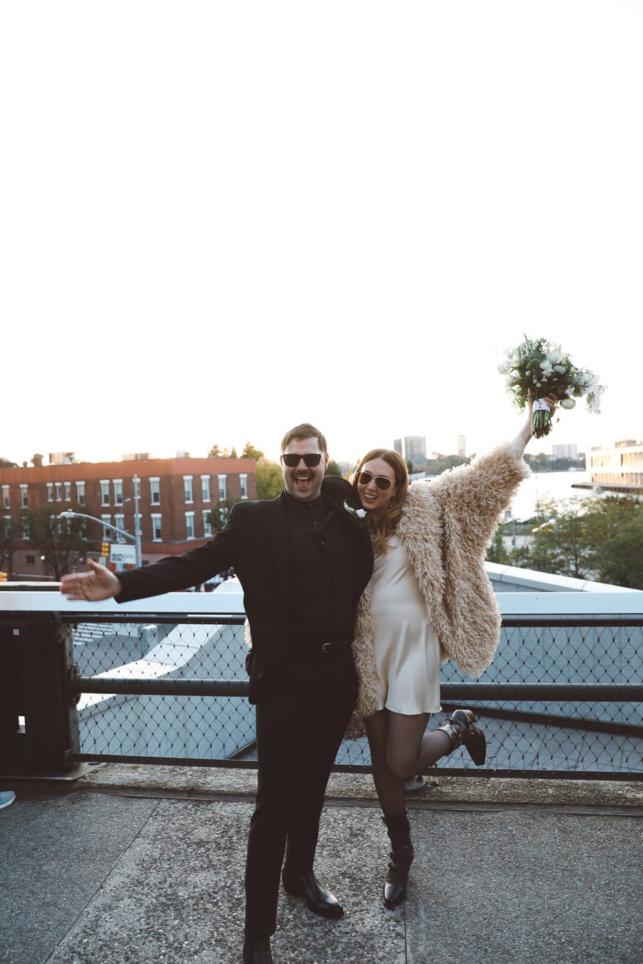 Couple cheering after getting married in NYC