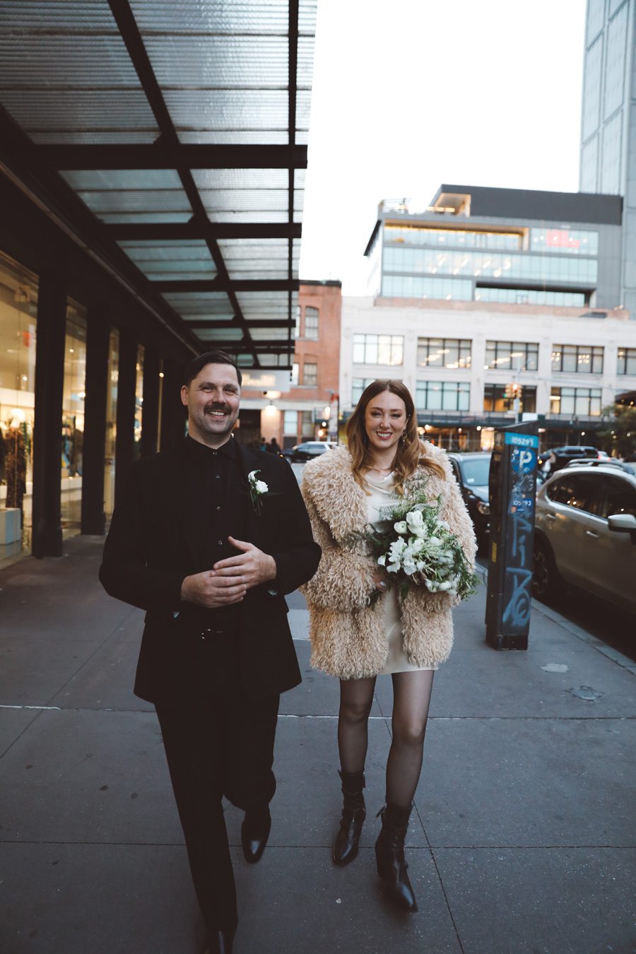 couple smiling while walking the streets of NYC