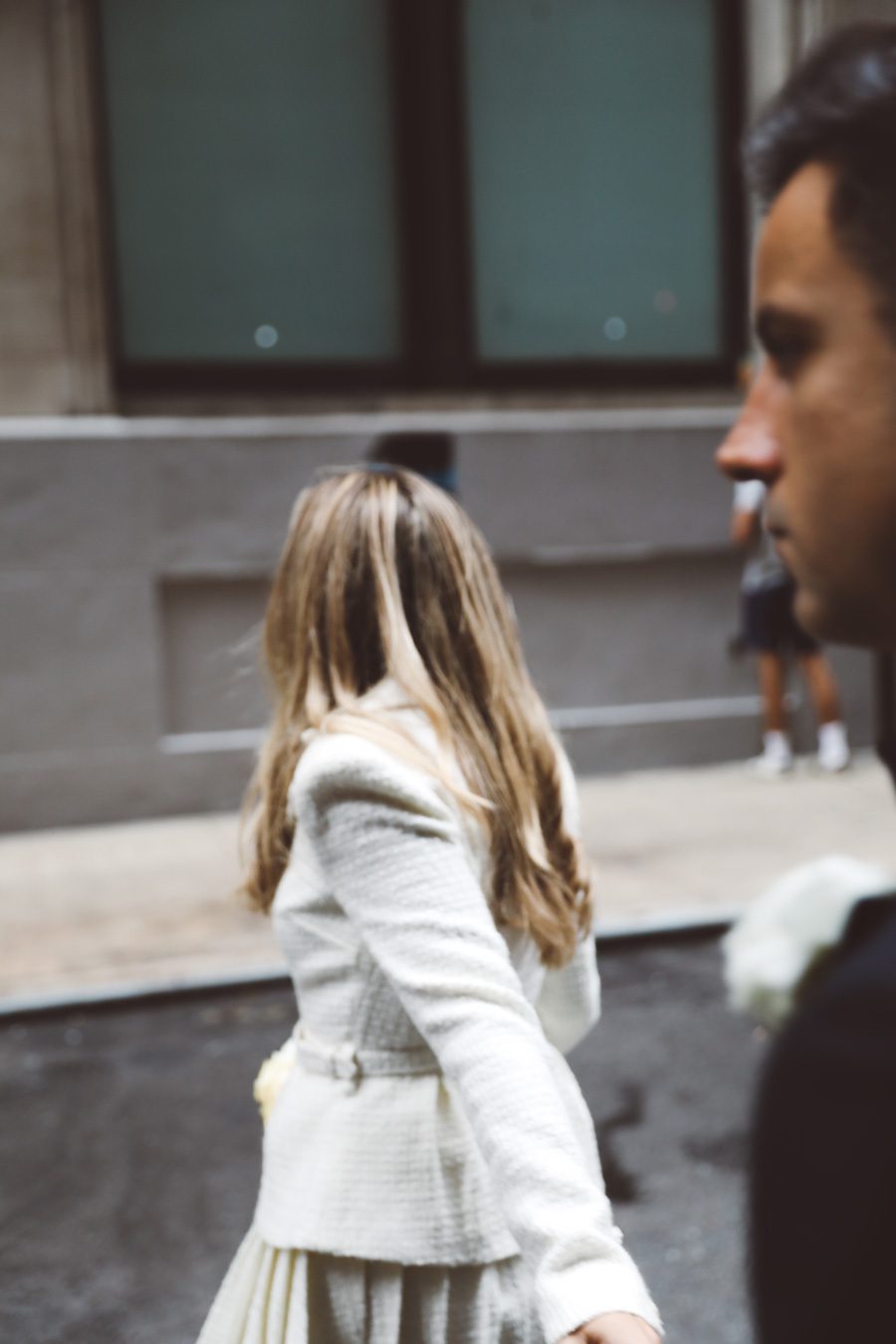 bride leads the groom to cross the street