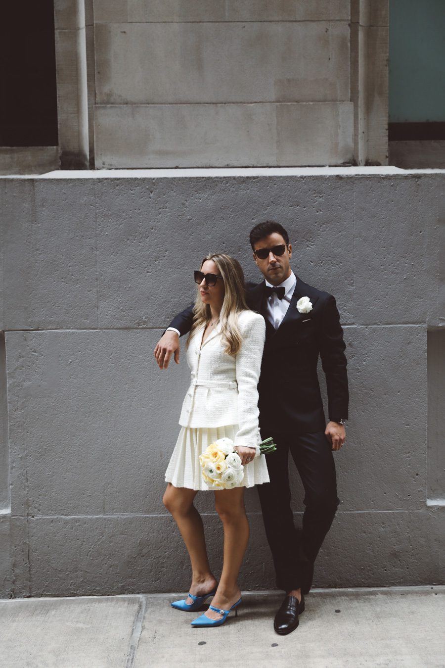 couple posing with sunglasses on