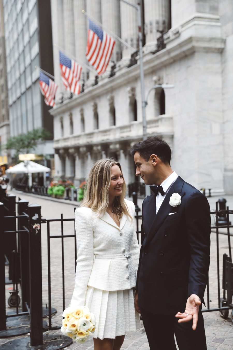 a couple talking while standing by Wall street