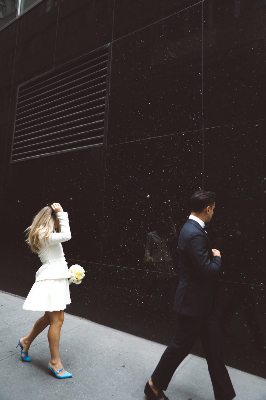 a candid shot of a couple walking in nyc