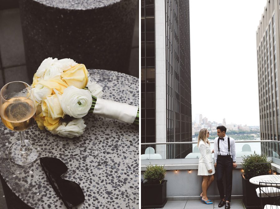 a table with glasses flowers and wine and a couple on a rooftop bar