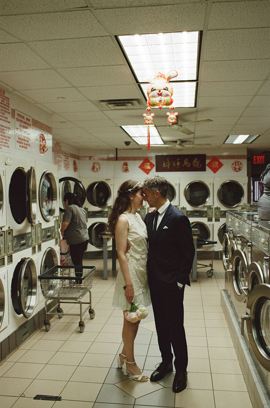 Elopement couple in a laundromat in Chinatown NYC